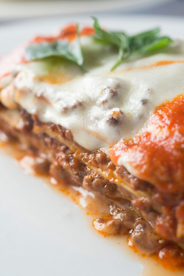 close up of lasagna with basil leaves