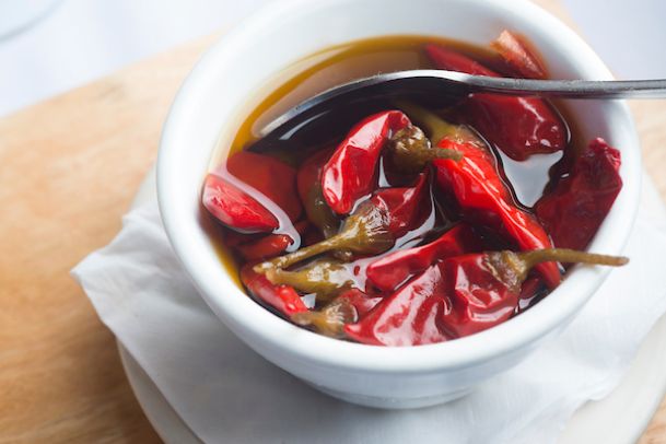 peppers in oil in small white bowl