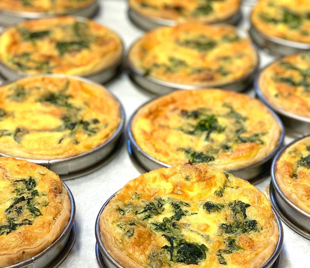 individual-serving quiches in their baking pans